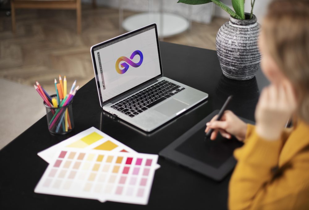female-logo-designer-working-her-tablet-connected-laptop